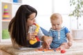 Mom and baby playing musical toys at home Royalty Free Stock Photo