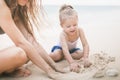 Mom and baby playing near beach. Traveling with family, child Royalty Free Stock Photo