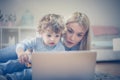 Mom and baby son watching cartoons on laptop. Royalty Free Stock Photo