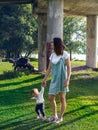 Mom and baby walk in the upland park on a sunny summer day