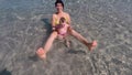 Mom with a baby in the water while relaxing at sea. Child body tempering.