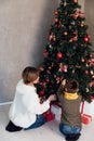 Mom with boy decorating christmas tree with gifts for new year Royalty Free Stock Photo