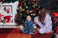 Mom and boy open presents at Christmas tree decor new year Royalty Free Stock Photo