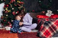 Mom and boy open presents at Christmas tree decor new year Royalty Free Stock Photo