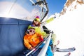 Mom with boy on ski lift ropeway chair Royalty Free Stock Photo