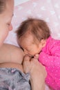 Mom breastfeeding her baby girl. The baby girl is 15 days old. Concept of lactation infant. Royalty Free Stock Photo