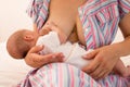 The mom is breastfeeding her newborn baby on the bed Royalty Free Stock Photo