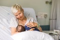 Mom breastfeeding her newborn baby boy in a hospital Royalty Free Stock Photo