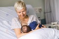 Mom breastfeeding her newborn baby boy in a hospital Royalty Free Stock Photo