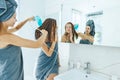 Mom brushing hair to her daughter in hotel bathroom Royalty Free Stock Photo