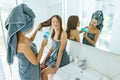 Mom brushing hair to her daughter in hotel bathroom Royalty Free Stock Photo