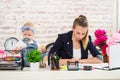 Mom and businesswoman working with laptop computer at home and playing with her baby girl. Royalty Free Stock Photo