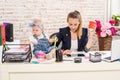 Mom and businesswoman working with laptop computer at home and playing with her baby girl. Royalty Free Stock Photo