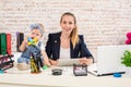 Mom and businesswoman working with laptop computer at home and playing with her baby girl. Royalty Free Stock Photo