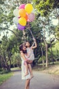 Mom carrying his daughter with nature and sunlight, enjoyment family Royalty Free Stock Photo