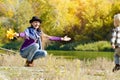 Mom catches running son. Autumn, a sunny day. River bank