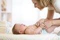 Mother changing a diaper on newborn baby