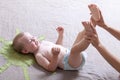 Mom changing diaper to the baby lying on his back Royalty Free Stock Photo