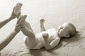 Mom changing diaper to the baby lying on his back Royalty Free Stock Photo