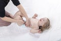 Mom changing diaper to the baby lying on his back Royalty Free Stock Photo