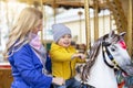 Mom with a cheerful baby on a carousel
