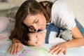 Mom with a child in bed. Happy loving family. Mother and her daughter child girl playing together Royalty Free Stock Photo