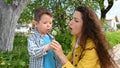Mom and child blow out a dandelion