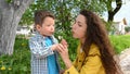 Mom and child blow out a dandelion