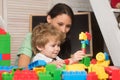 Mom and child build out of colorful plastic blocks. Royalty Free Stock Photo