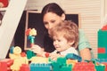 Mom and child build out of colorful plastic blocks. Royalty Free Stock Photo