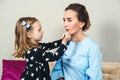 Mom and child girl are doing make up. Happy mother and daughter having fun at home together. Happy family concept Royalty Free Stock Photo