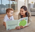 Mom, child and reading dinosaur books on living room floor at family home for educational fun, learning and happy