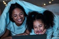 Mom, child and tablet with blanket in bedroom at night to play games, social media and reading ebook. Happy mother, girl Royalty Free Stock Photo