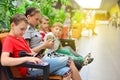 Mom with children on the bench in the mall. Photo with tinting