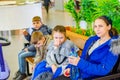 Mom with children on a bench for a rest while walking