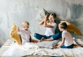 .Mom with children fights pillows