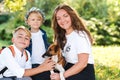 Mom and children having fun playing with dog outdoors. Happy family enjoying in park on sunny a day Royalty Free Stock Photo