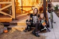 Mom and children in the same skeleton costume for Halloween. Masquerade holiday on October 31st autumn.