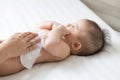 Mom cleaning up and wipe body baby by wet tissue when changing nappies or diaper and wiping the hands or face or leg, Personal Royalty Free Stock Photo