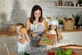 Mom cooks lunch with the kids. A woman teaches her daughter to cook from her son. Vegetarianism and healthy natural food Royalty Free Stock Photo