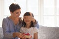 Mom cover daughter eyes with hands prepared surprise for her Royalty Free Stock Photo