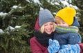 Mom and cute child warm hat scarf. Winter fashion concept. Happy girl playing with kid winter day. Enjoying wintertime Royalty Free Stock Photo