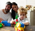 Mom, dad and boy build out of colorful blocks Royalty Free Stock Photo