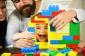 Mom, dad and boy build out of plastic blocks Royalty Free Stock Photo