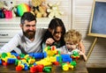 Mom, dad and boy build out of plastic blocks Royalty Free Stock Photo