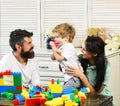 Mom, dad and boy with toys on wooden background Royalty Free Stock Photo