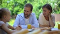 Mom and dad carefully listening to girl telling about achievements, being proud