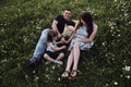 Young Caucasian European happy family with half breed white Swiss Shepherd is enjoying life. Mom dad daughter and big fluffy white Royalty Free Stock Photo