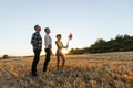 Mom, dad and daughter having fun in the field at sunset. Royalty Free Stock Photo