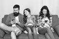 Mom dad and daughter relaxing on couch. Family leisure. Play game application. Online family. Family spend weekend Royalty Free Stock Photo